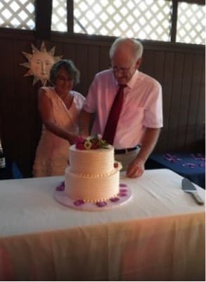 older couple slicing their wedding cake