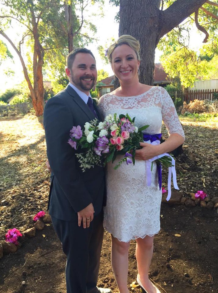 newly married couple smiling to the camera