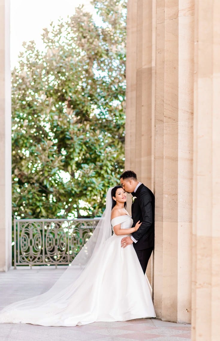 groom kissing the bride on the forehead