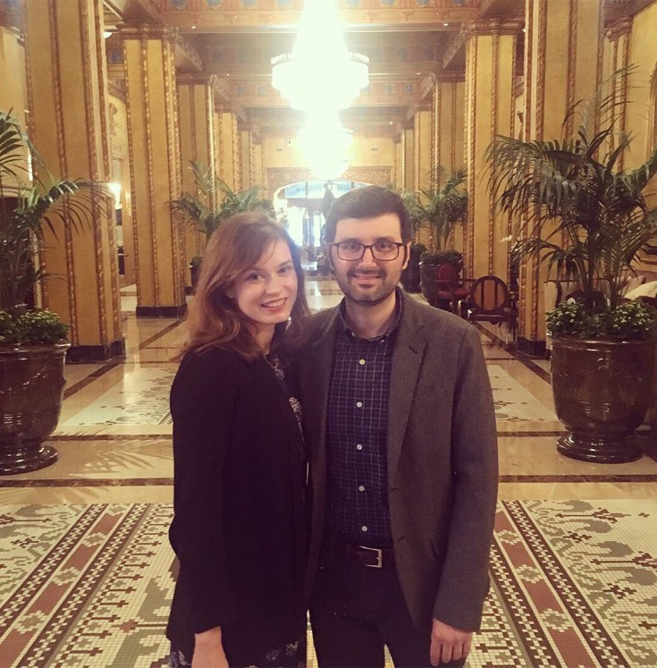 young, happy couple posing for a picture in the hallway