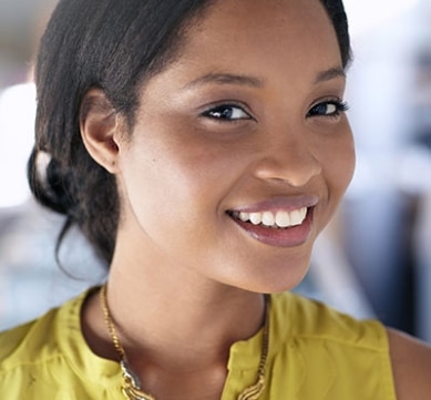 young, woman of color wearing a yellow sleeveless top