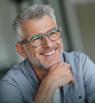 older man wearing glasses and smiling