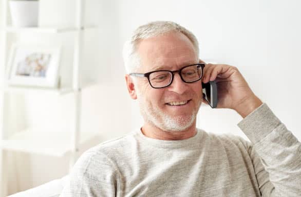 an older man wearing eyeglasses talking on his phone