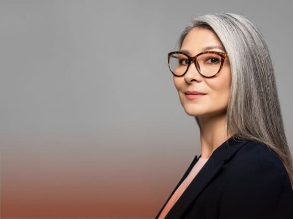 a business woman with long hair, wearing eyeglasses