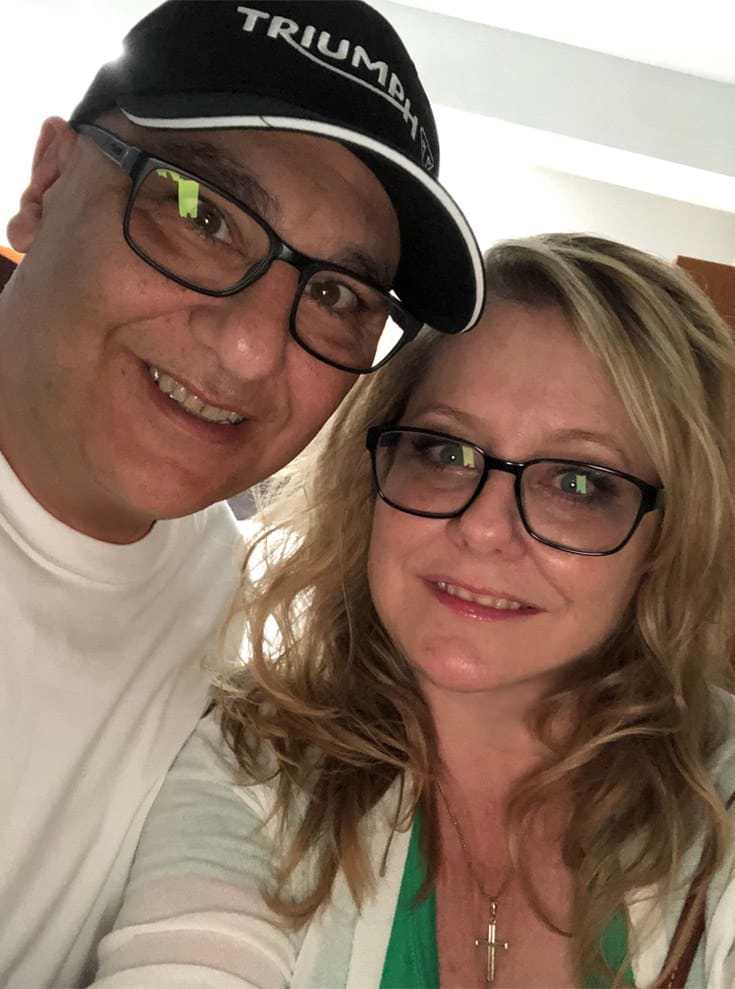 blonde, middle-aged woman with her husband wearing eyeglasses