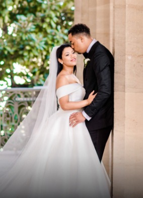 groom giving her bride a kiss on the forehead - love u success story